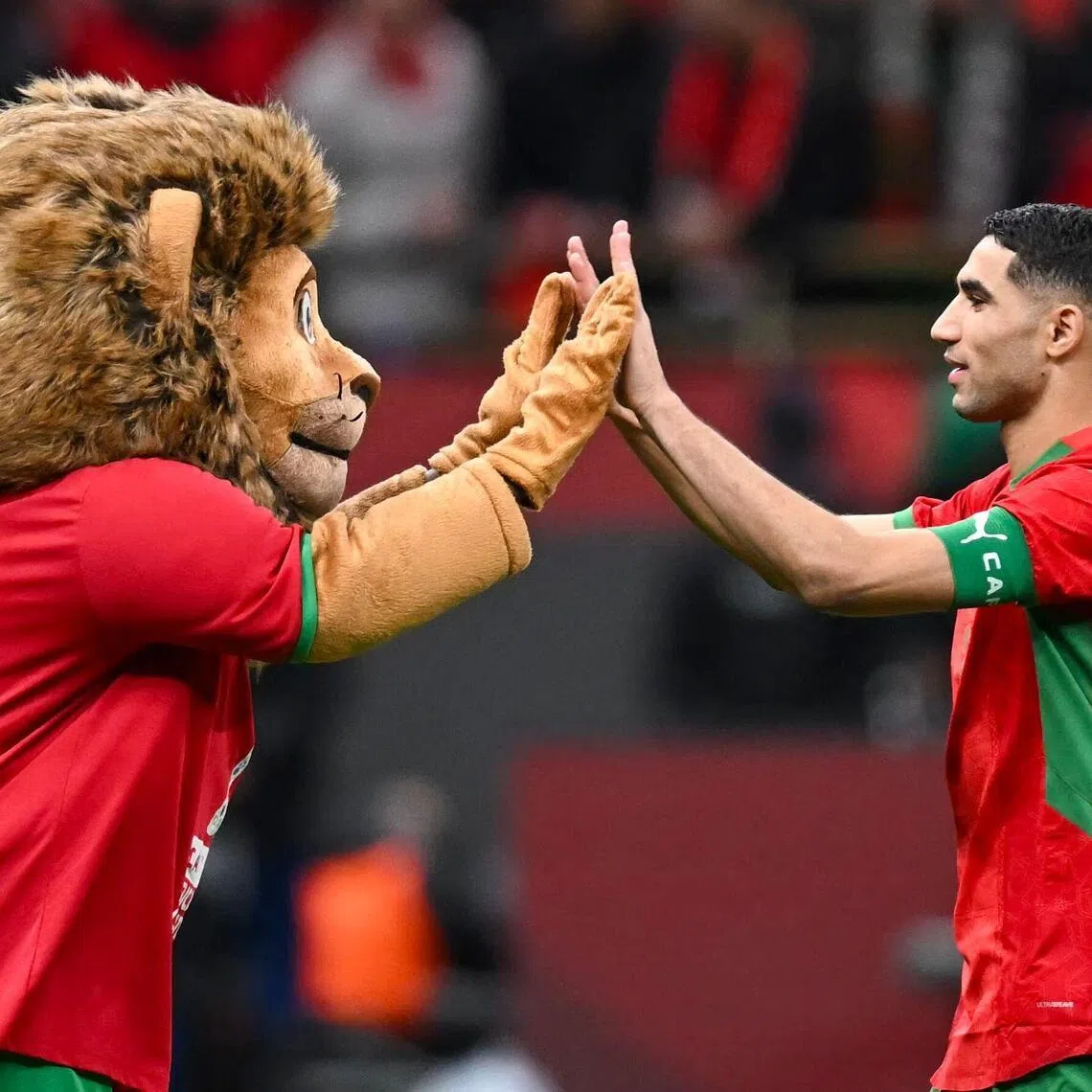 Morocco captain and defender Achraf Hakimi celebrating with the Atlas Lions' mascot after the Africa Cup of Nations semi-final shoot-out win over Nigeria at the Prince Moulay Abdellah stadium in Rabat on Jan 14, 2026.