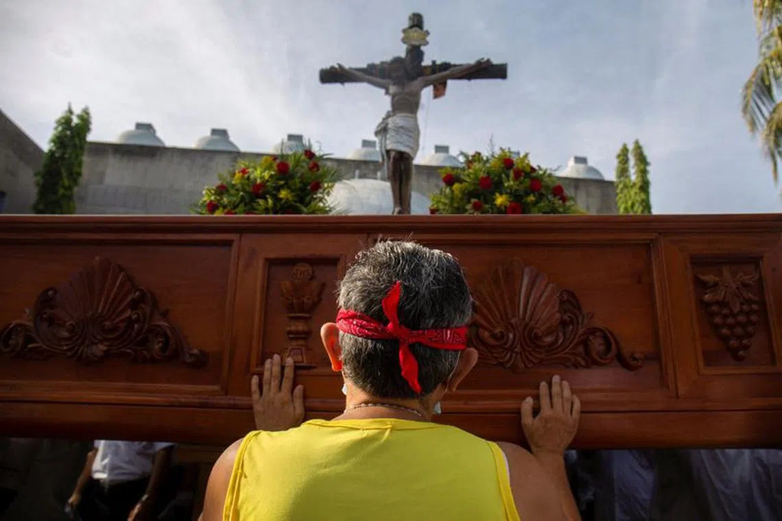 A Nicaraguan Catholic prays while blindfolded during a Good Friday procession at the Metropolitan Cathedral as the government banned Holy Week street processions this year due to unspecified security concerns, in Managua, Nicaragua April 7, 2023. REUTERS/Stringer/File Photo