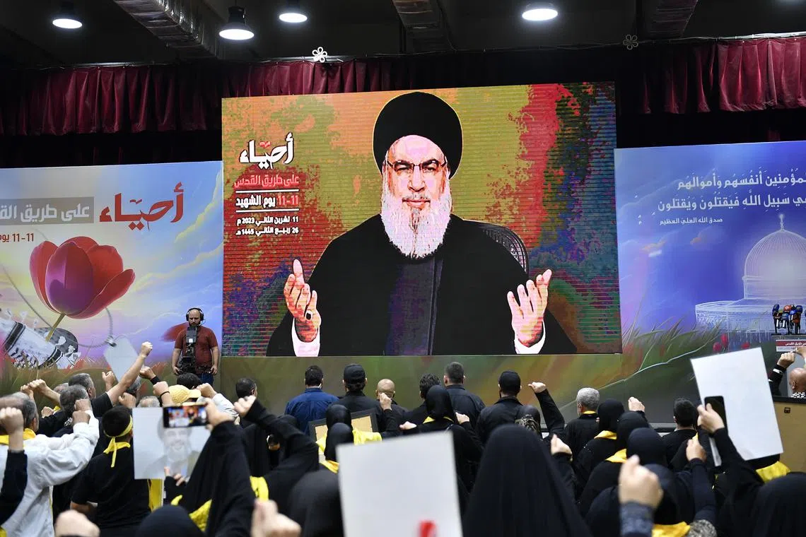 Hezbollah supporters listen to a speech by Hezbollah leader Hassan Nasrallah on the occasion of Hezbollah's annual 'Martyrs' Day', in the southern suburb of Beirut, Lebanon in November 2023. 