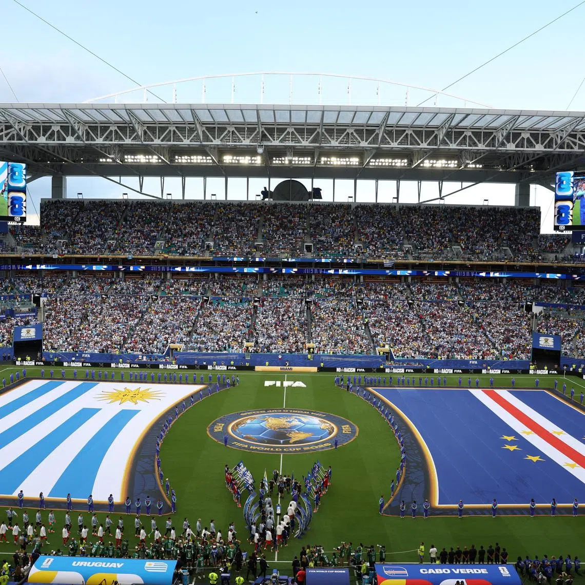 Soccer Football - FIFA World Cup 2026 - Group H -  Uruguay v Cape Verde - Miami Stadium, Miami Gardens, Florida, U.S. - June 21, 2026 General view inside the stadium of giant Uruguay and Cape Verde flags as the teams walk out onto the pitch before the match REUTERS/Paul Childs