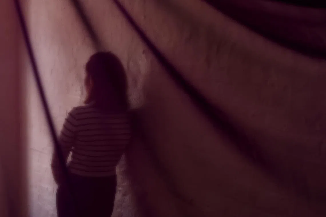 FILE PHOTO: A suspected victim of modern slavery, who was initially denied state support after Britain introduced a tougher immigration policy, poses for a portrait following an interview with Reuters in London, Britain, September 19, 2024. REUTERS/Hannah McKay/File Photo