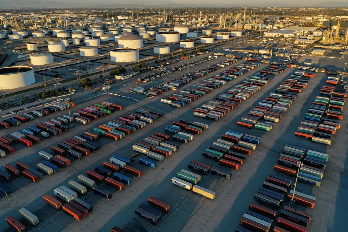 FILE PHOTO: Cargo shipping containers are seen adjacent to storage tanks at Marathon Petroleum's Los Angeles Refinery, which processes crude oil into California Air Resources Board (CARB), gasoline, diesel fuel, and other petroleum products, in Carson, California, U.S., March 11, 2022. Picture taken March 11, 2022. Picture taken with a drone. REUTERS/Bing Guan/File Photo