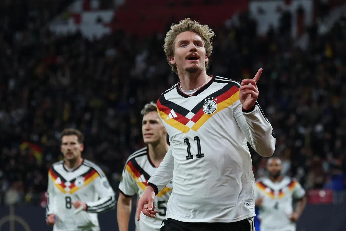 Nick Woltemade of Germany celebrates after scoring against Slovakia in a World Cup qualifier.