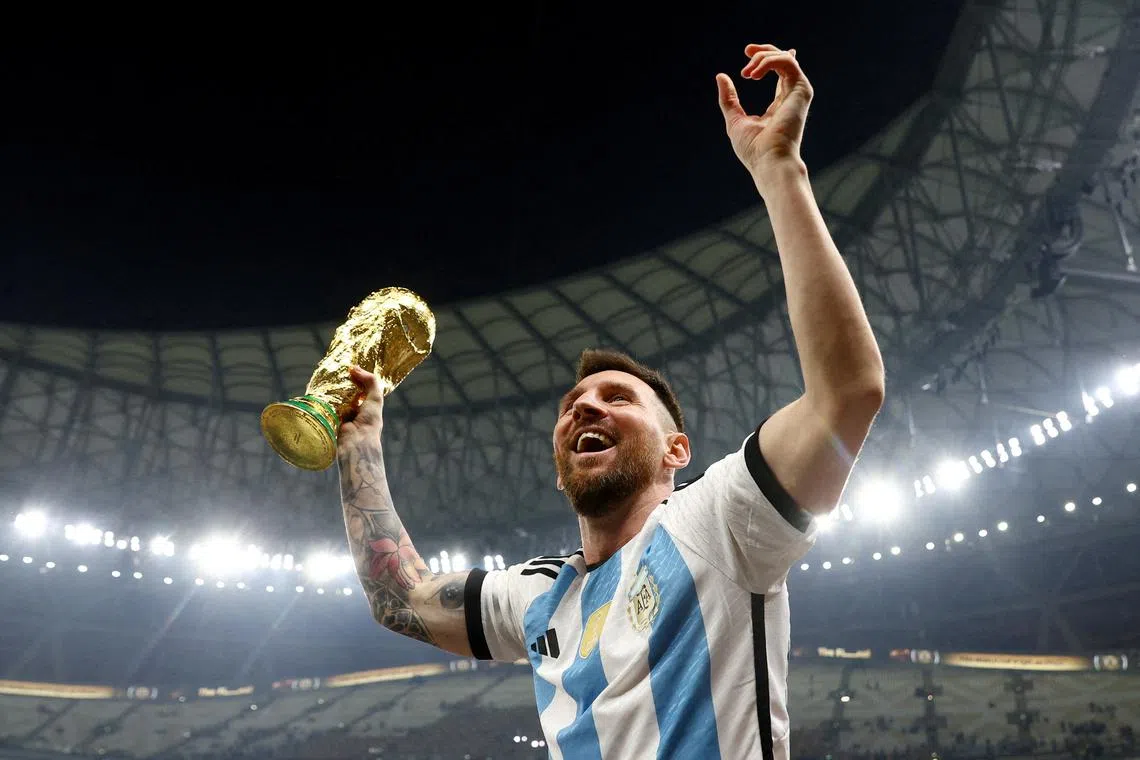 FILE PHOTO: Soccer Football - FIFA World Cup Qatar 2022 - Final - Argentina v France - Lusail Stadium, Lusail, Qatar - December 18, 2022   Argentina's Lionel Messi celebrates winning the World Cup with the trophy REUTERS/Hannah Mckay/File Photo