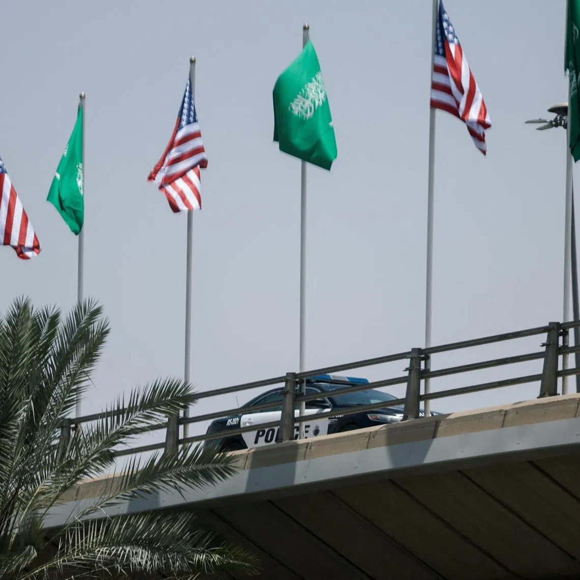 FILE PHOTO: U.S. and Saudi flags flutter along a highway of Riyadh, as pictured through the glass of a car, ahead of the arrival of U.S. President Donald Trump to Riyadh, Saudi Arabia May 12, 2025. REUTERS/Hamad I Mohammed/File Photo