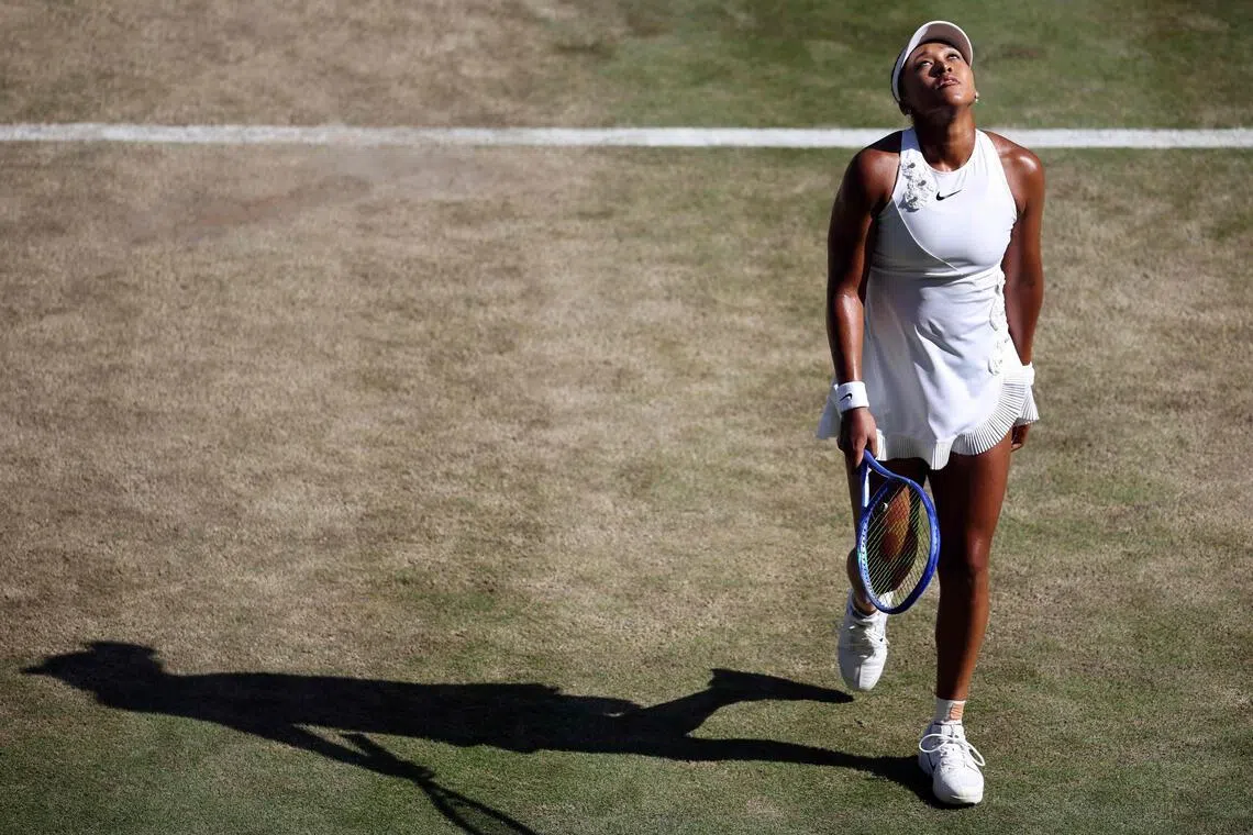 Japan's Naomi Osaka reacts as she plays against Czech Republic's Karolina Muchova during their women's singles quarter-final tennis match on the ninth day of the 2026 Wimbledon Championships at The All England Lawn Tennis and Croquet Club in Wimbledon, southwest London, on July 7, 2026. (Photo by Henry NICHOLLS / AFP) / RESTRICTED TO EDITORIAL USE
