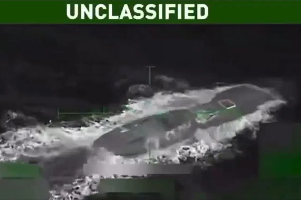 A screenshot from a video posted online of an earlier US strike on a vessel in the Pacific Ocean.
