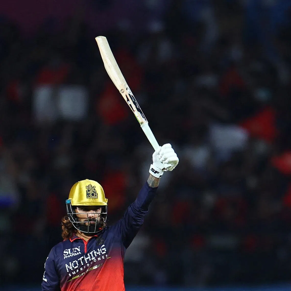 Cricket - Indian Premier League - IPL - Qualifier 1 - Royal Challengers Bengaluru v Gujarat Titans - Himachal Pradesh Cricket Association Stadium, Dharamshala, India - May 26, 2026  Royal Challengers Bengaluru's Rajat Patidar celebrates reaching his half century REUTERS/Anushree Fadnavis