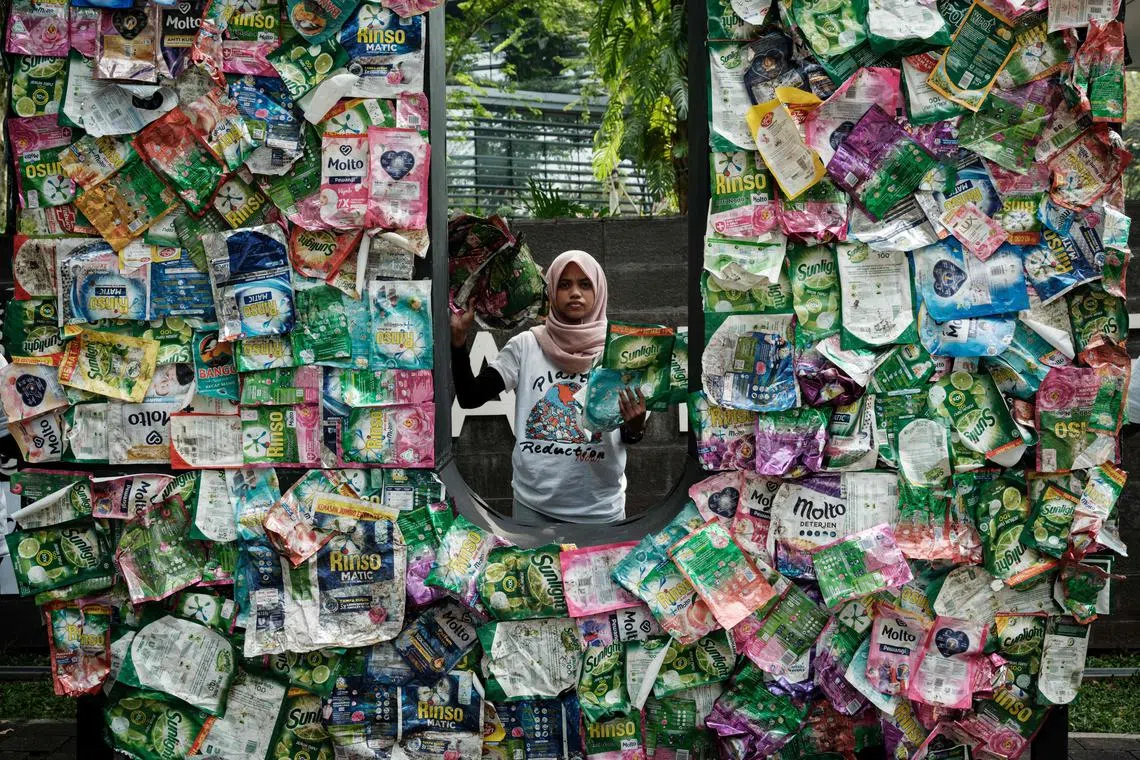 Members of Greenpeace Indonesia displaying plastic waste from British multi-national hygiene and food giant Unilever's products, as part of their “Return to Sender” action, in front of Unilevers office in Tangerang, a suburb of Jakarta, on June 20, 2024. 