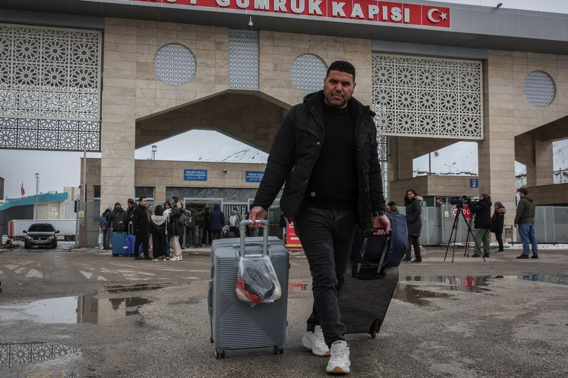Mr Mohammad Fauzi, 46, arrives in Turkey from Iran near the Kapikoy border gate in Van province, Turkey, on March 5.