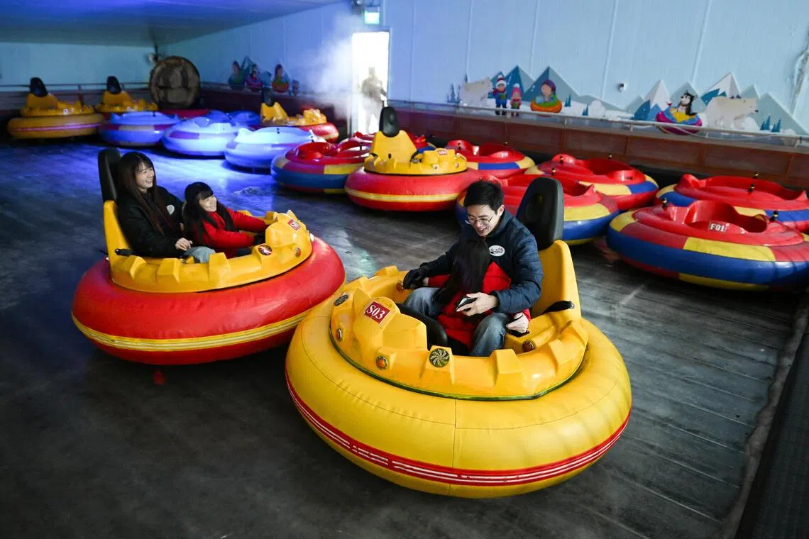 Visitors enjoying themselves on the Drift on Ice bumper car ride.