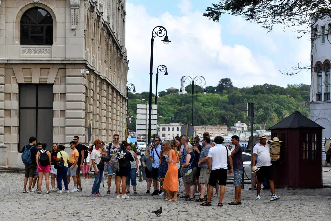 Tourists gather at a plaza, after Cuba's power-grid operator said it had restored electricity to parts of the capital, Havana on Oct 21.