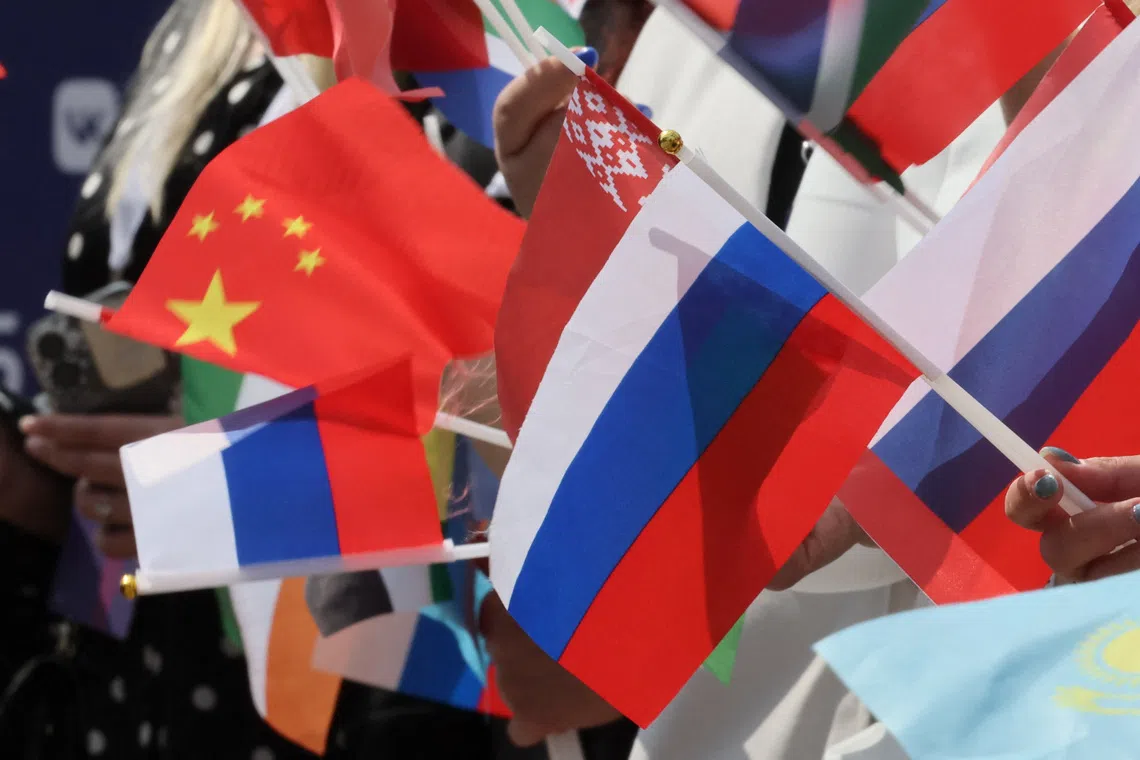 FILE PHOTO: Spectators wave flags of Russia, China and other countries during a ceremony, which marks the 100-day countdown to the start of the Intervision Song Contest, in central Moscow, Russia, June 12, 2025. Russia, which was banned from Eurovision in 2022, plans to revive the Soviet-era Intervision international music contest in September 2025. REUTERS/Shamil Zhumatov/File Photo