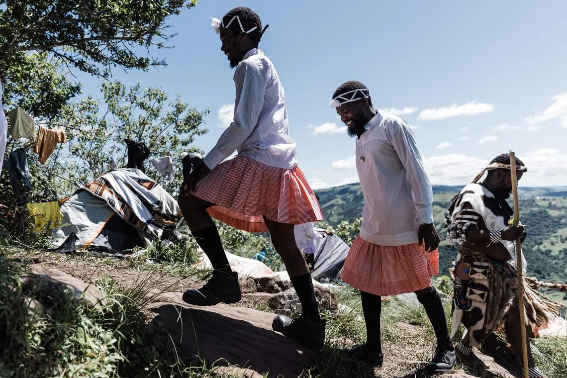 Dressed in traditional attirefollowers of the Nazareth Baptist Church, from the Ekuphakameni group, also known as the Shembe Church, climb the Nhlangakazi Holy Mountain in Ndwedwe 85km north of Durban, on Jan 8, 2023. 