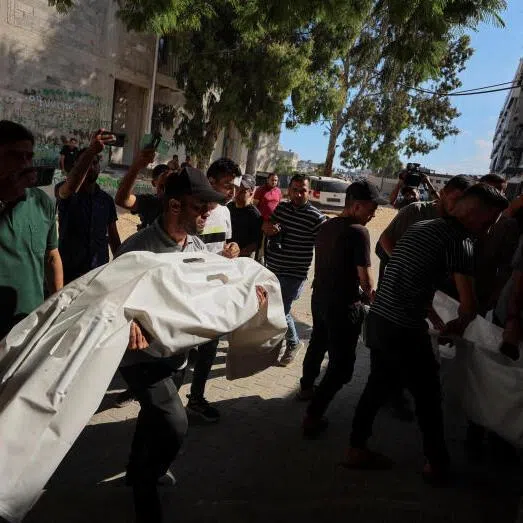 Mourners carrying bodies during the funeral of Palestinians killed in an Israeli strike, according to medics, at Al-Shifa Hospital in Gaza City, June 20, 2026.