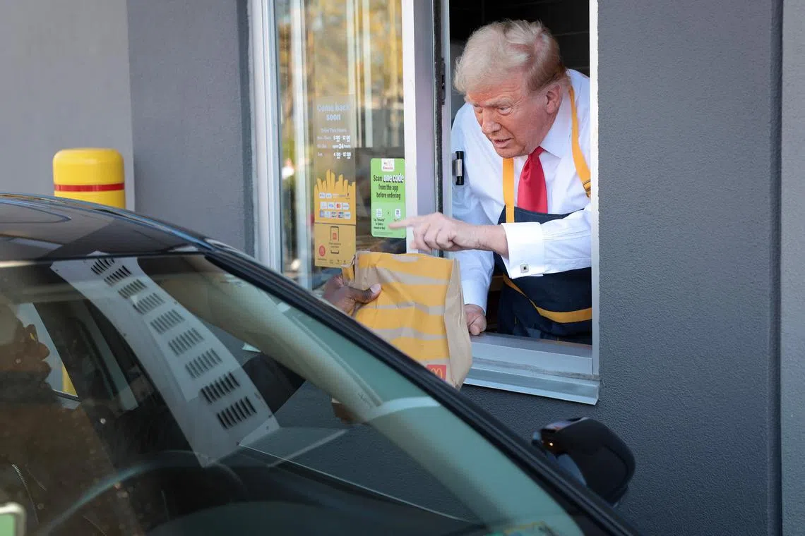 Trump works the drive-through line as he visits a McDonald's restaurant on Oct 20, 2024 in Feasterville-Trevose, Pennsylvania. 