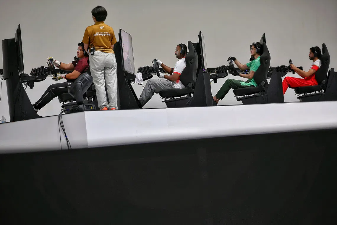 (FOR SPORTS FEATURE, PLEASE DO NOT SHARE OR USE WITHOUT PERMISSION) E-sports athletes, one of whom is Muhammad Aleef (in white) of Singapore, racing to the finish line during the Gran Turismo 7 auto-racing final at Aichi Sky Expo in Nagoya, Japan on Sept 23, 2026. ST PHOTO: KEVIN LIM