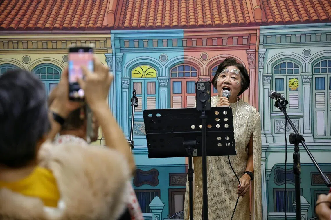Chong Lian How, 71, recording her video for TikTok at the Sing, Shine, Share event on Aug 29.