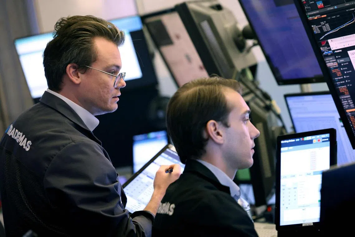 Traders work on the floor of the New York Stock Exchange, in New York City.