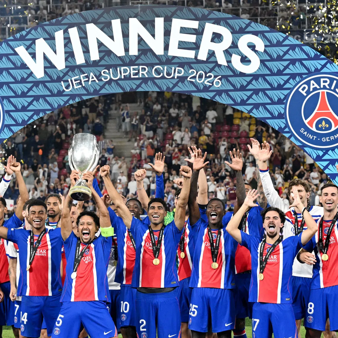 Paris St Germain’s Marquinhos lifts the trophy with teammates after winning the UEFA Super Cup.