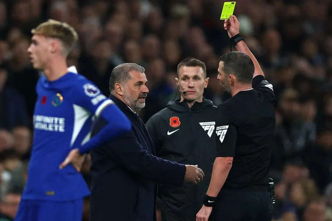 Soccer Football - Premier League - Tottenham Hotspur v Chelsea - Tottenham Hotspur Stadium, London, Britain - November 6, 2023 Tottenham Hotspur manager Ange Postecoglou is shown a yellow card by referee Michael Oliver Action Images via Reuters/Matthew Childs