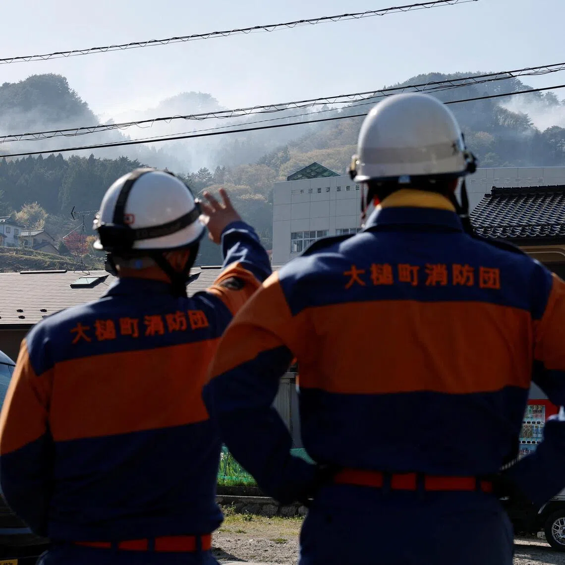 Volunteer firefighters watch a wildfire from the fire station in Otsuchi, Iwate Prefecture, Japan, April 26, 2026. REUTERS/Kim Kyung-Hoon
     TPX IMAGES OF THE DAY