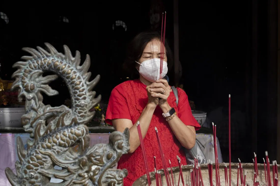 A person takes part in Vesak Day celebrations at a temple in Denpasar, Bali, Indonesia, on June 4, 2023. Buddhists celebrate Vesak Day to mark the date of the birth, enlightenment and passing of Buddha.