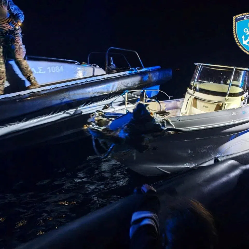 A boat that was carrying migrants is seen alongside a Greek Coast Guard patrol vessel following a collision in which six migrants died, off Lesbos, Greece, October 19, 2026. Hellenic Coast Guard/Handout via REUTERS