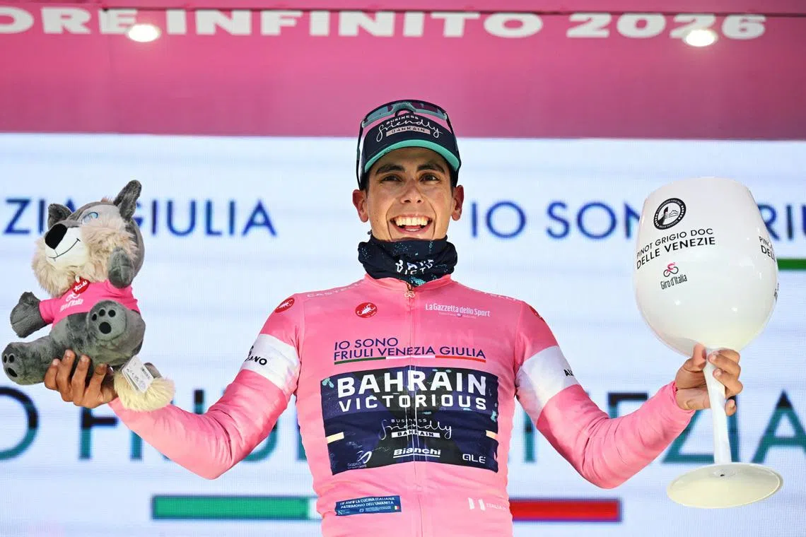 Cycling - Giro d'Italia - Stage 5 - Praia a Mare to Potenza - Italy - May 13, 2026 Bahrain - Victorious' Afonso Eulalio celebrates wearing the maglia rosa jersey on the podium after stage 5 REUTERS/Jennifer Lorenzini