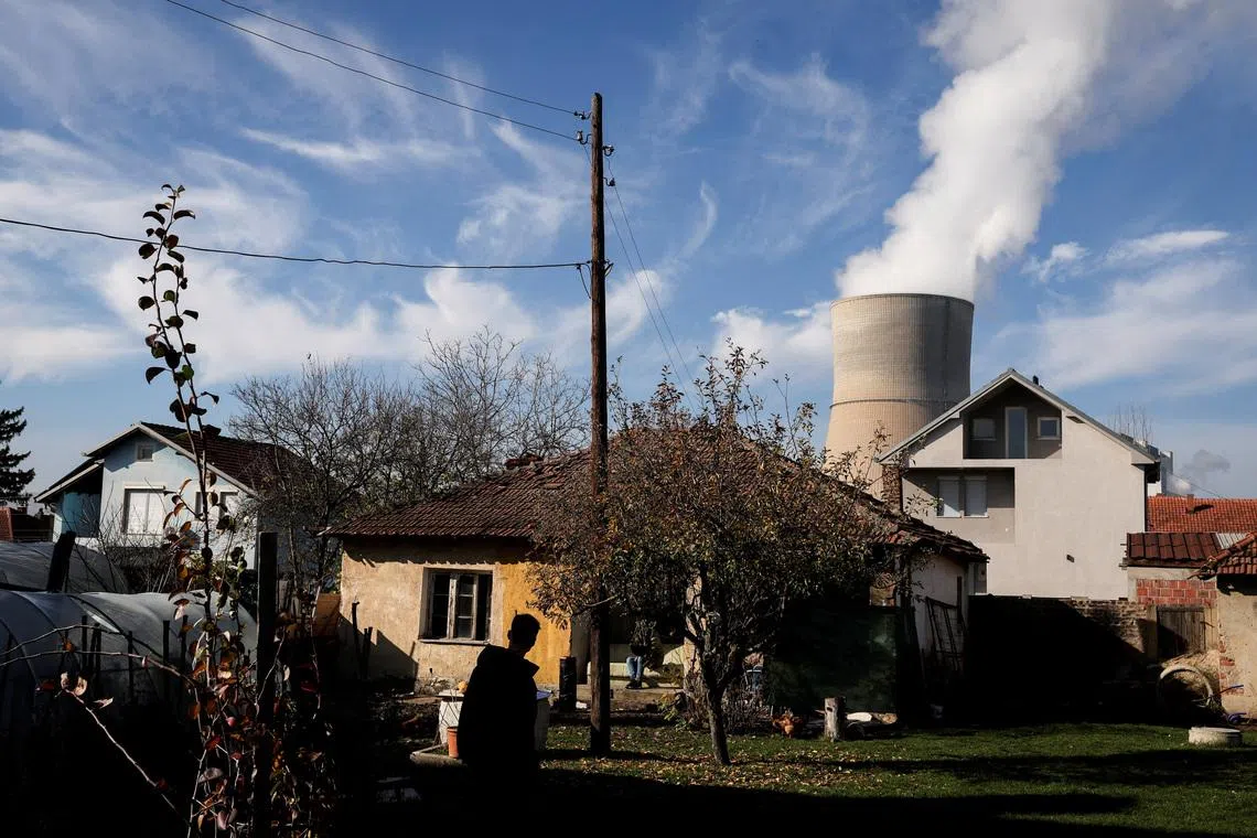 A man walks at his garden near the coal-fired power plant in Obilic, Kosovo November 13, 2025. REUTERS/Valdrin Xhemaj/File Photo