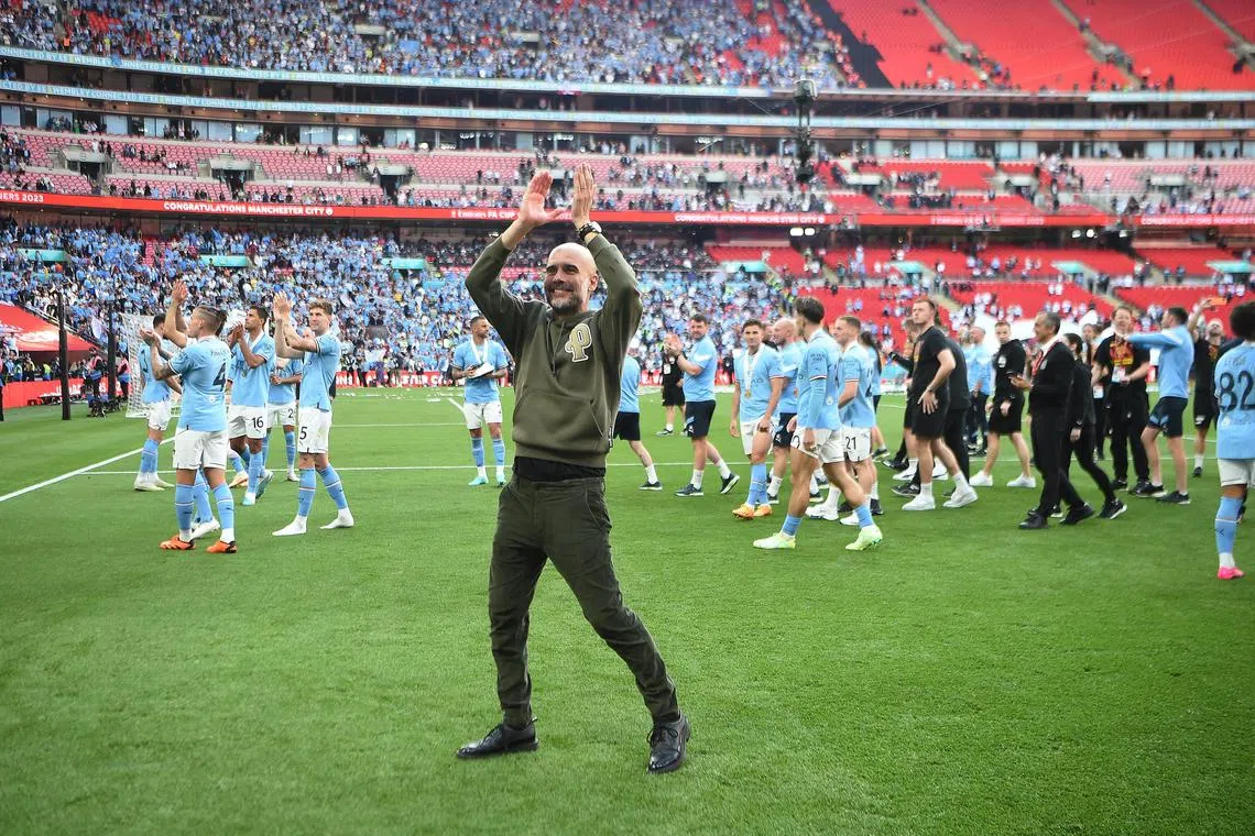 Manchester City manager Pep Guardiola celebrates after winning the FA Cup.