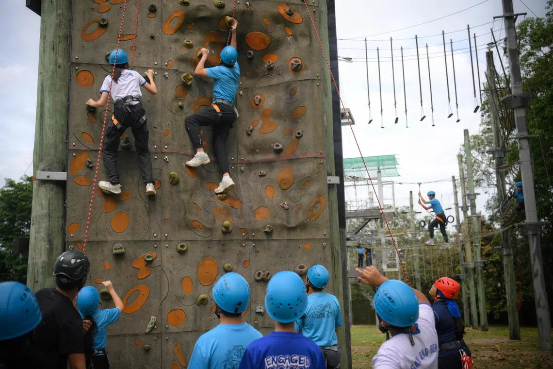 Students from Gan Eng Seng Secondary School make their way up a climbing wall at the Jalan Bahtera Outdoor Adventure Learning Centre (OALC) on February 1, 2023.