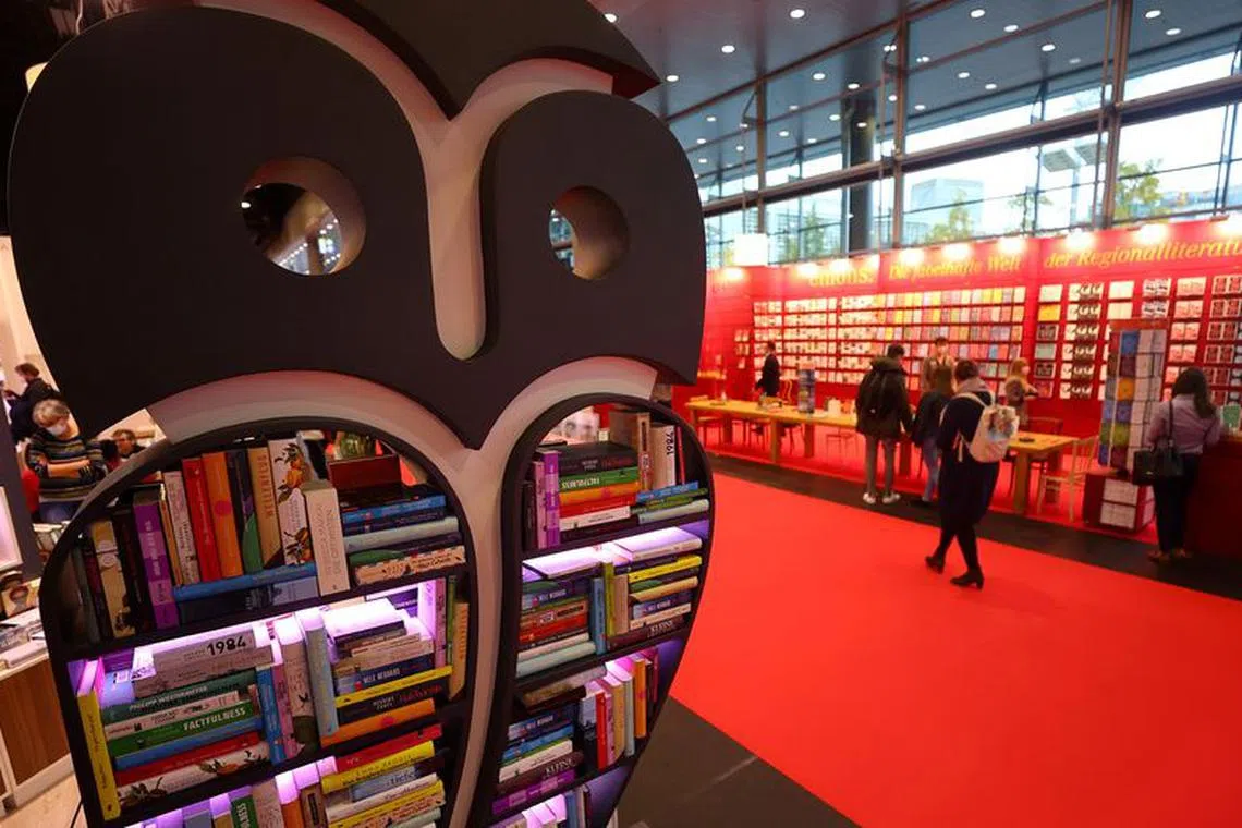FILE PHOTO: Visitors are seen at the world's largest book fair in Frankfurt, Germany, October 21, 2021.  REUTERS/Kai Pfaffenbach/File Photo