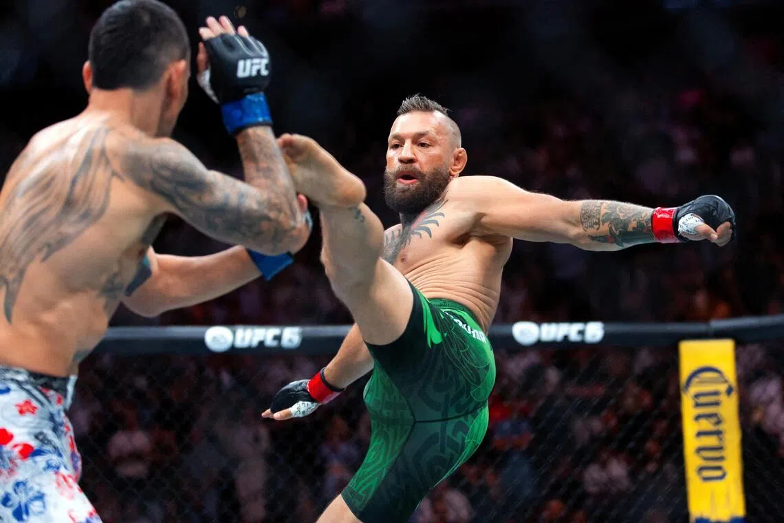 Jul 11, 2026; Las Vegas, Nevada, USA; Conor McGregor (right) attempts a flying kick at the start of his fight against Max Holloway during UFC 329 at T-Mobile Arena. Mandatory Credit: Mark J. Rebilas-Imagn Images     TPX IMAGES OF THE DAY