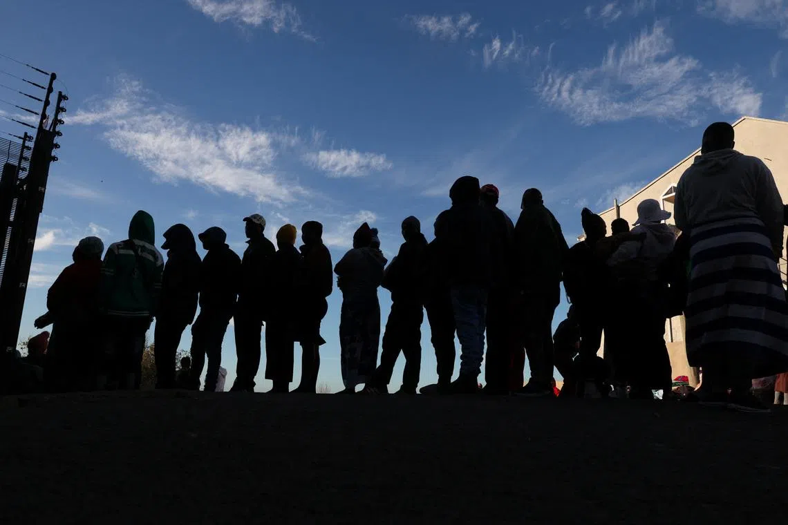 Zimbabwean migrants queue outside the Zimbabwe Consulate amid fears of anti-immigrant violence ahead of a June 30 deadline set by activists demanding undocumented migrants leave the country, in Cape Town, South Africa, June 24, 2026. REUTERS/Esa Alexander