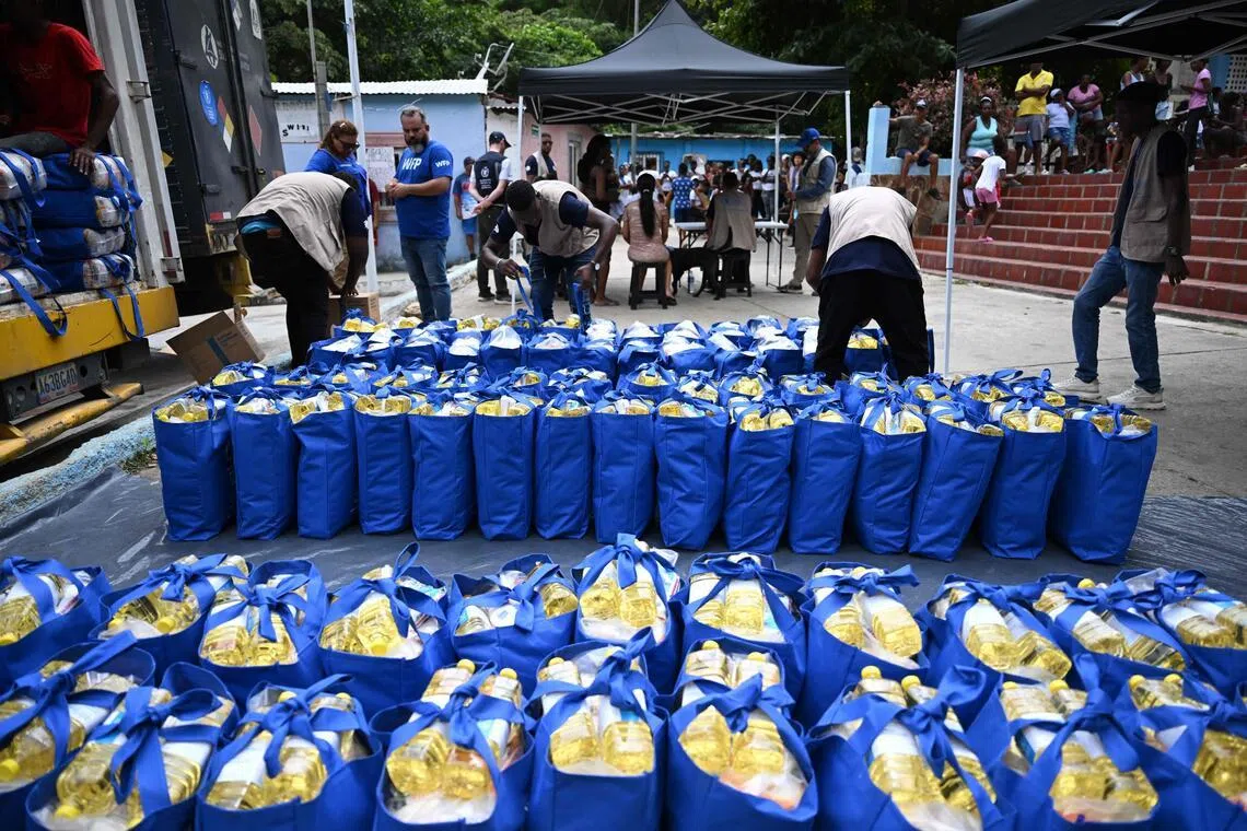 Workers unload donations from the World Food Programme in Chichiriviche de la Costa, La Guaira state, Venezuela, on July 16.