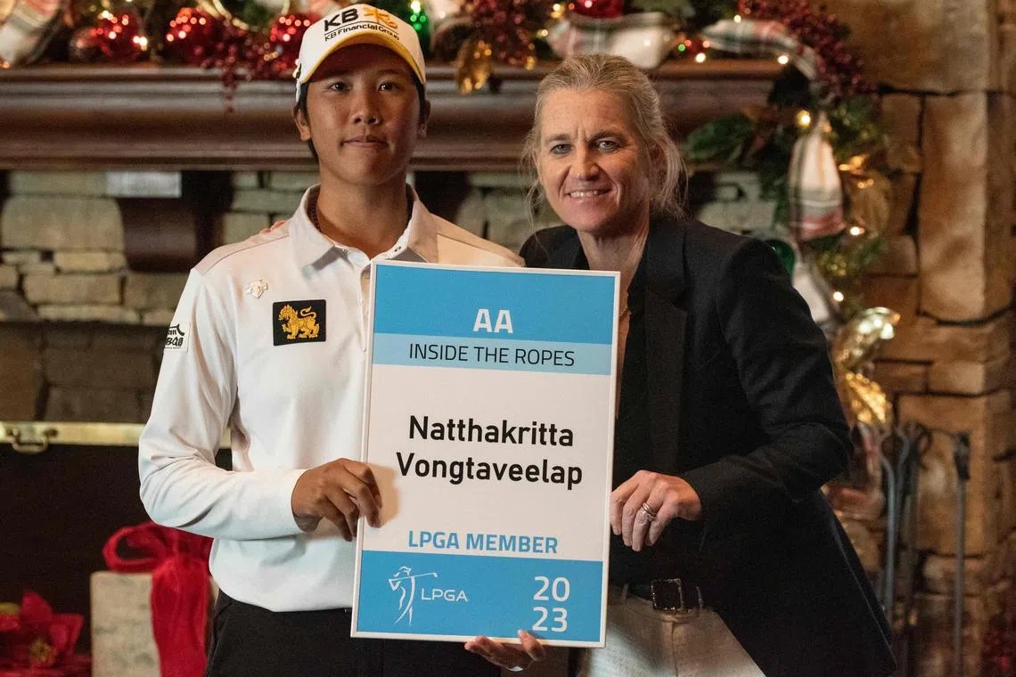 Natthakritta Vongtaveelap and LPGA Tour commissioner Mollie Marcoux Samaan pose with her tour card.