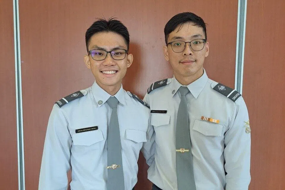 then-me4 trainee me4t chow (left) pictured with coursemate then-me4t jonathan ee during the military domain expert course phase 1 graduation ceremony in 2023