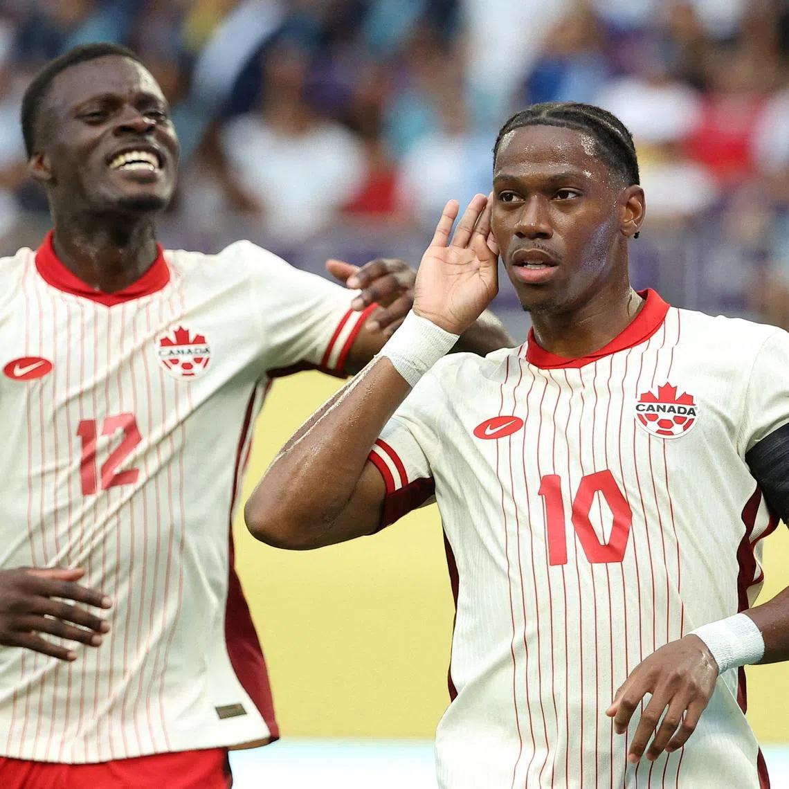 FILE PHOTO: Jun 29, 2025; Minneapolis, Minnesota, USA; Canada forward Jonathan David (10) celebrates with forward Tani Oluwaseyi (12) after scoring a goal against Guatemala in the first half during a quarterfinal match of the 2025 Gold Cup at U.S. Bank Stadium. Mandatory Credit: Matt Krohn-Imagn Images/File Photo