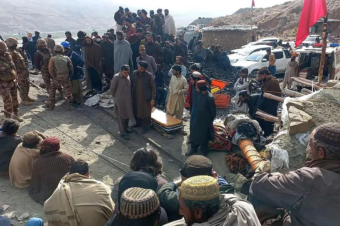 Miners gathered outside a collapsed mine as rescue personnel conduct a search operation for trapped workers after a gas explosion rocked the private coal pit in the mining region of Khost at Harnai district, Balochistan province. 