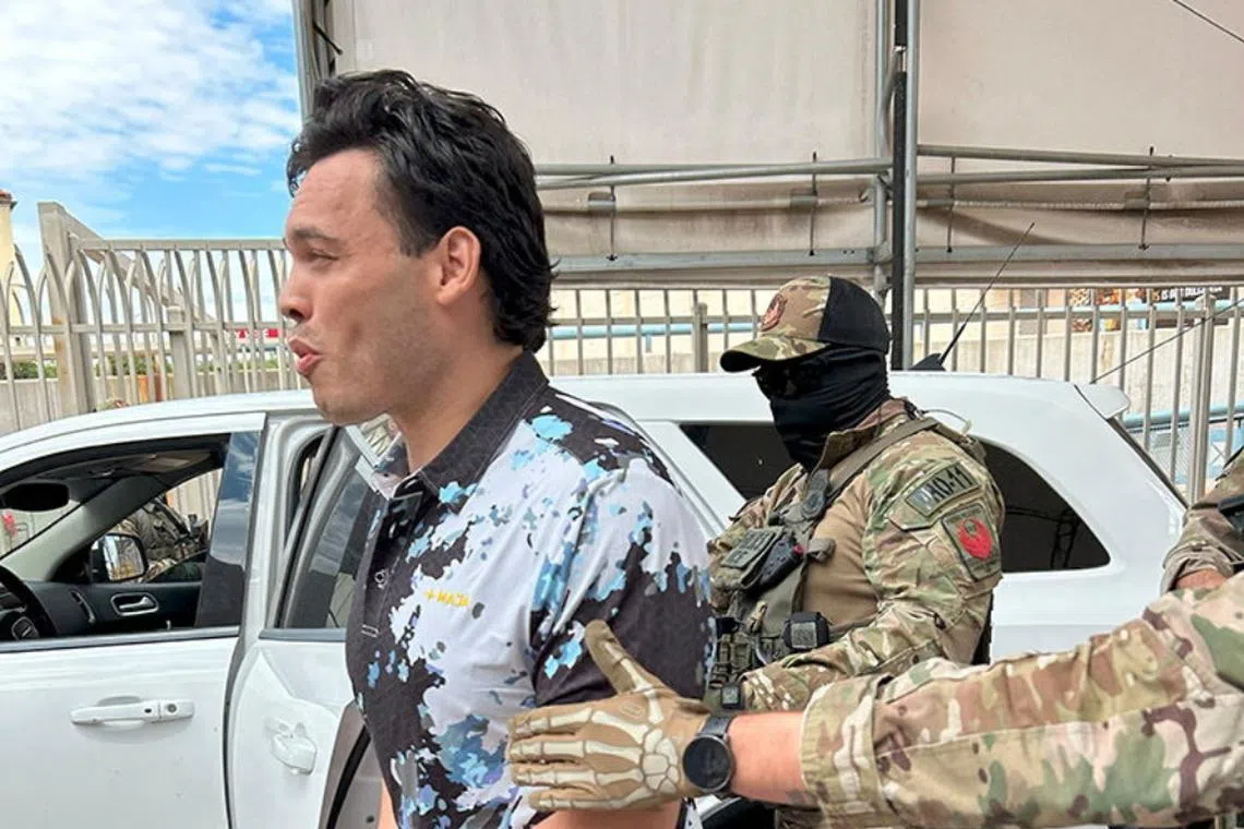 US Immigration and Customs Enforcement officers escort Mexican boxer Julio Cesar Chavez Jr as he is deported through Arizona's Nogales Port of Entry, on Aug 21.