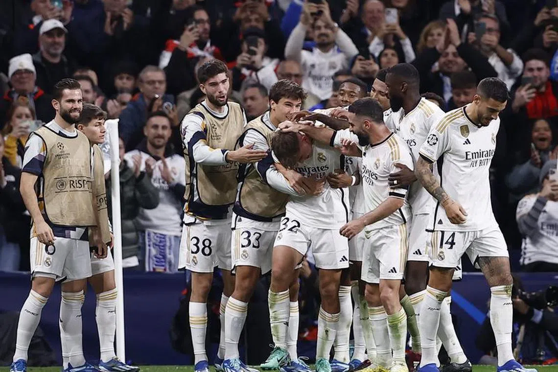 Soccer Football - Champions League - Group C - Real Madrid v Napoli - Santiago Bernabeu, Madrid, Spain - November 29, 2023 Real Madrid's Nico Paz celebrates scoring their third goal with teammates REUTERS/Juan Medina