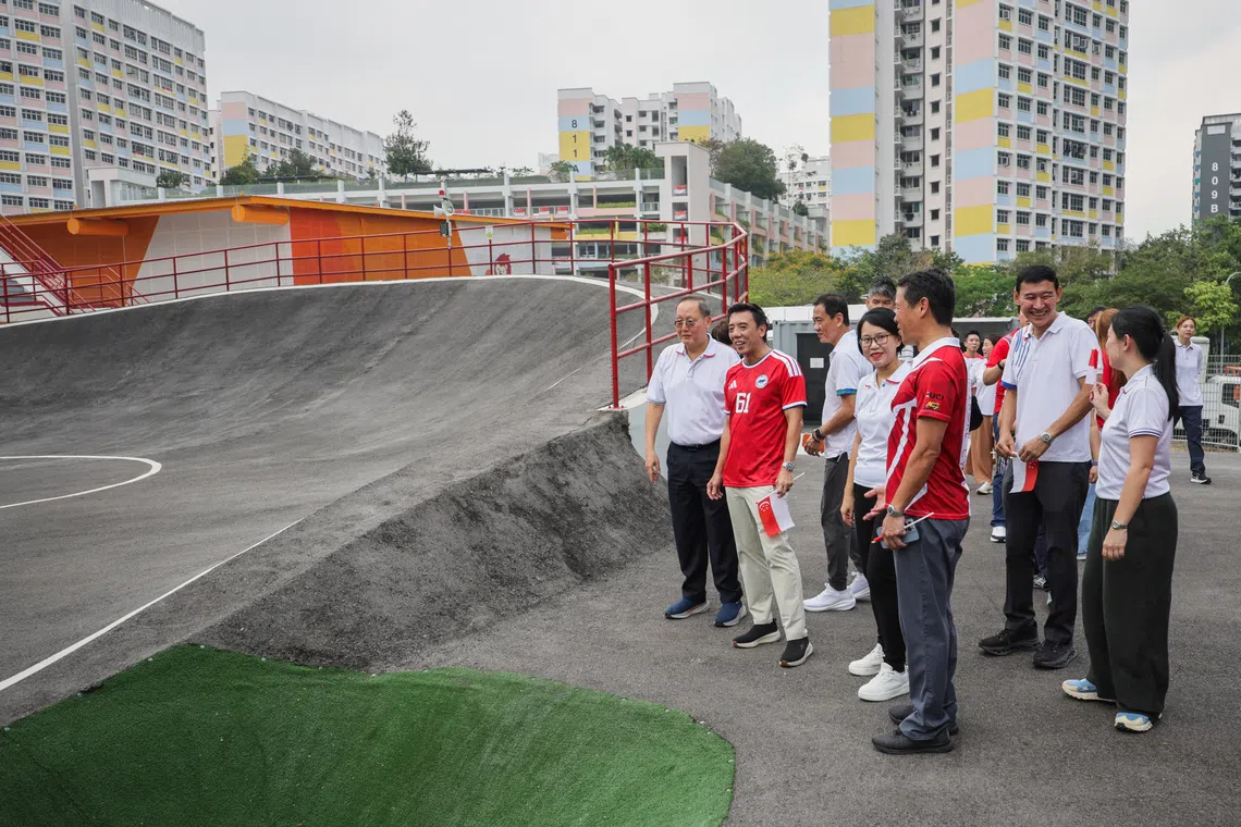 Minister for Trade and Industry (Energy & Industry) Tan See Leng (left) and Minister for Transport Jeffrey Siow (2nd from left) touring the facilities at The Bricks, including the existing Cycle Park onAug 15.