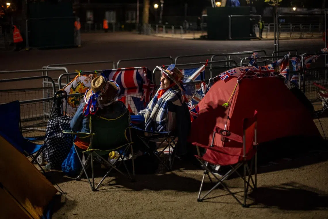 Royal fans wait on the coronation procession route on The Mall in London, Britain, May 3, 2023. Britain's King Charles III's Coronation takes place at Westminster Abbey in London on May 6. 