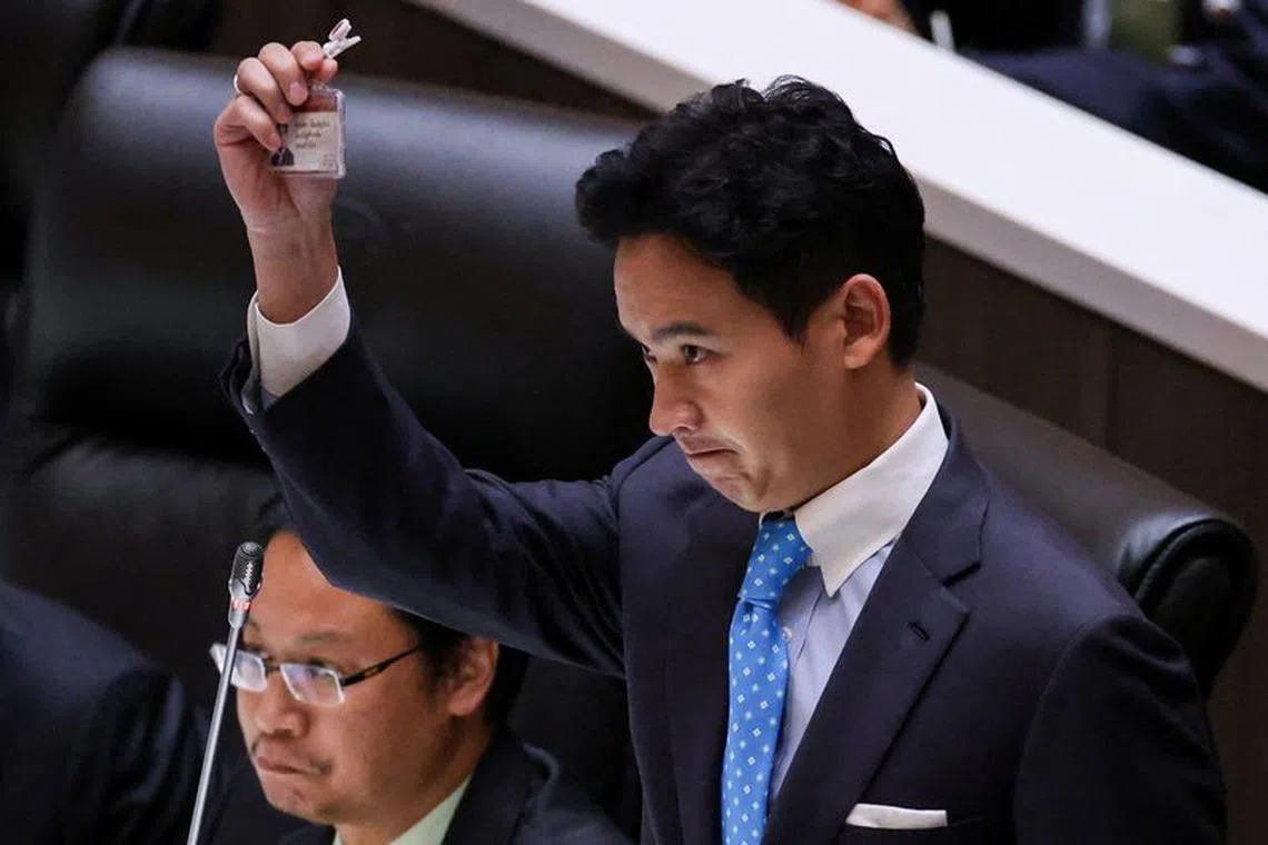 FILE PHOTO: Pita Limjaroenrat, leader of the Move Forward Party holds up his ID card at parliament after Thailand's Constitutional Court ordered his temporary suspension from the parliament, on the day of the second vote for a new prime minister, in Bangkok, Thailand, July 19, 2023. REUTERS/Chalinee Thirasupa