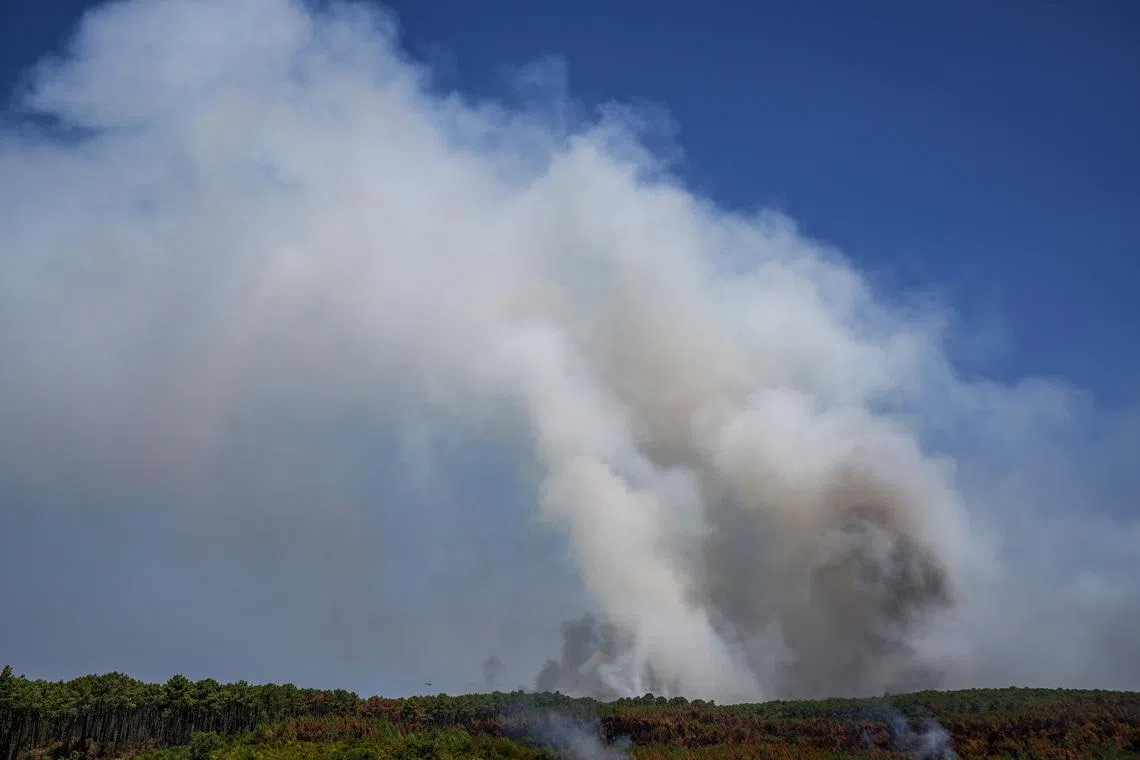 Smoke rises from a wildfire in Le Grand Crohot amid drought conditions following a heatwave and water shortages across much of France.