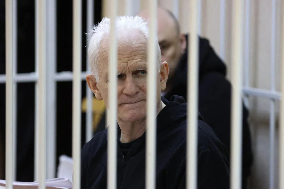 (FILES) In this file photo taken on January 05, 2023 Nobel Prize winner Ales Bialiatski is seen in the defendants' cage in the courtroom at the start of the hearing in Minsk. - A court in Belarus on March 3, 2023 sentenced Nobel Prize winner Ales Bialiatski to 10 years in prison, in a case his supporters see as punishment for his human rights work. The Viasna rights group founded by Bialiatski said in a statement that the 60-year-old had been convicted of smuggling and financing "activities that grossly violate public order". (Photo by Vitaly PIVOVARCHIK / BELTA / AFP) / Belarus OUT