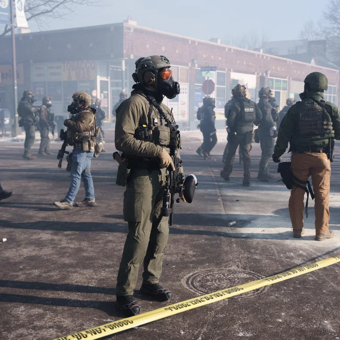 Federal agents stand amid teargas near the site where a man identified as Alex Pretti was fatally shot by federal agents trying to detain him, in Minneapolis, Minnesota, U.S., January 24, 2026.REUTERS/Tim Evans