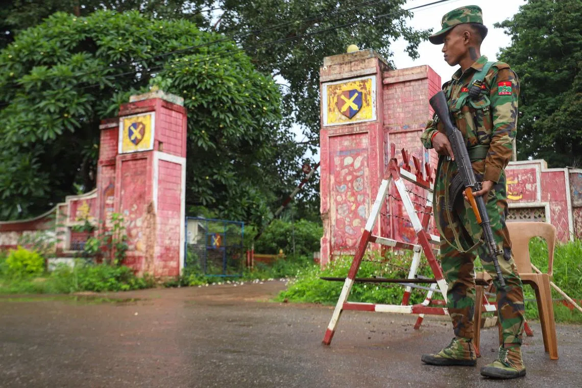 A member of the ethnic armed group Ta'ang National Liberation Army stands guard in the town of Kyaukme in Myanmar's northern Shan State, on July 3.