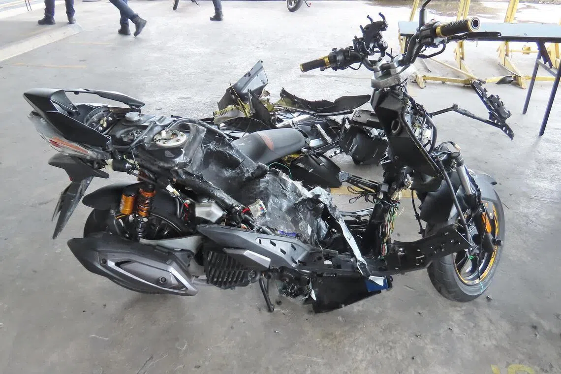 A motorcycle’s bodywork taken apart after ICA officers flagged the vehicle for attempted smuggling of contraband cigarettes in 2025.
